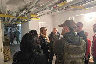 Angelina Jolie and others indoors with flak jackets, in Kherson